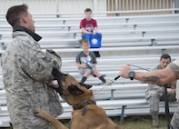 Arco, a Belgian Malinois military working dog, barks at Staff Sgt. Corbin Carlson, during the Duke Field Wing Day event Nov. 7. Eglin’s MWD teams maintain training, conduct vehicle searches, base patrols, building sweeps and dormitory checks. They also deploy with other units and services due to their special skill sets. (U.S. Air Force photo/Tech. Sgt. Jasmin Taylor)