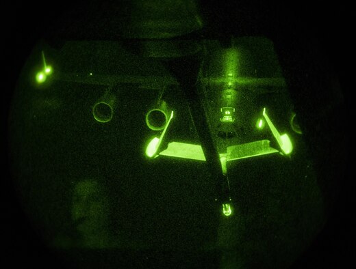 A reflection of Airman 1st Class Amy James, a 32nd Air Refueling Squadron boom operator, is shown while she refuels a C-17 Globemaster III over the Atlantic Ocean during Trident Juncture 2015, Nov. 3, 2015. Without the refueling capability of the KC-10, the C-17s would not have enough fuel to make it all the way to Spain from the United States. (U.S. Air Force photo/Staff Sgt. Douglas Ellis)