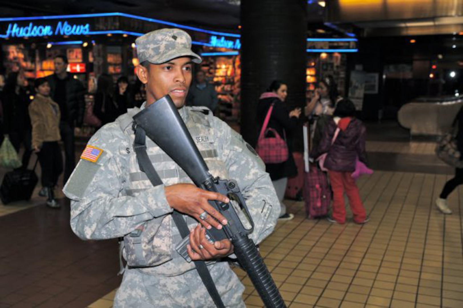 New York Army National Guard Spc. Melvin Seally, assigned to Joint Task Force Empire Shield, the New York National Guard's full-time security force in New York City, patrols Pennsylvania Station with police officers on Christmas Eve. The members of Joint Task Force Empire Shield will be on duty New Years Eve supporting civilian police agencies.