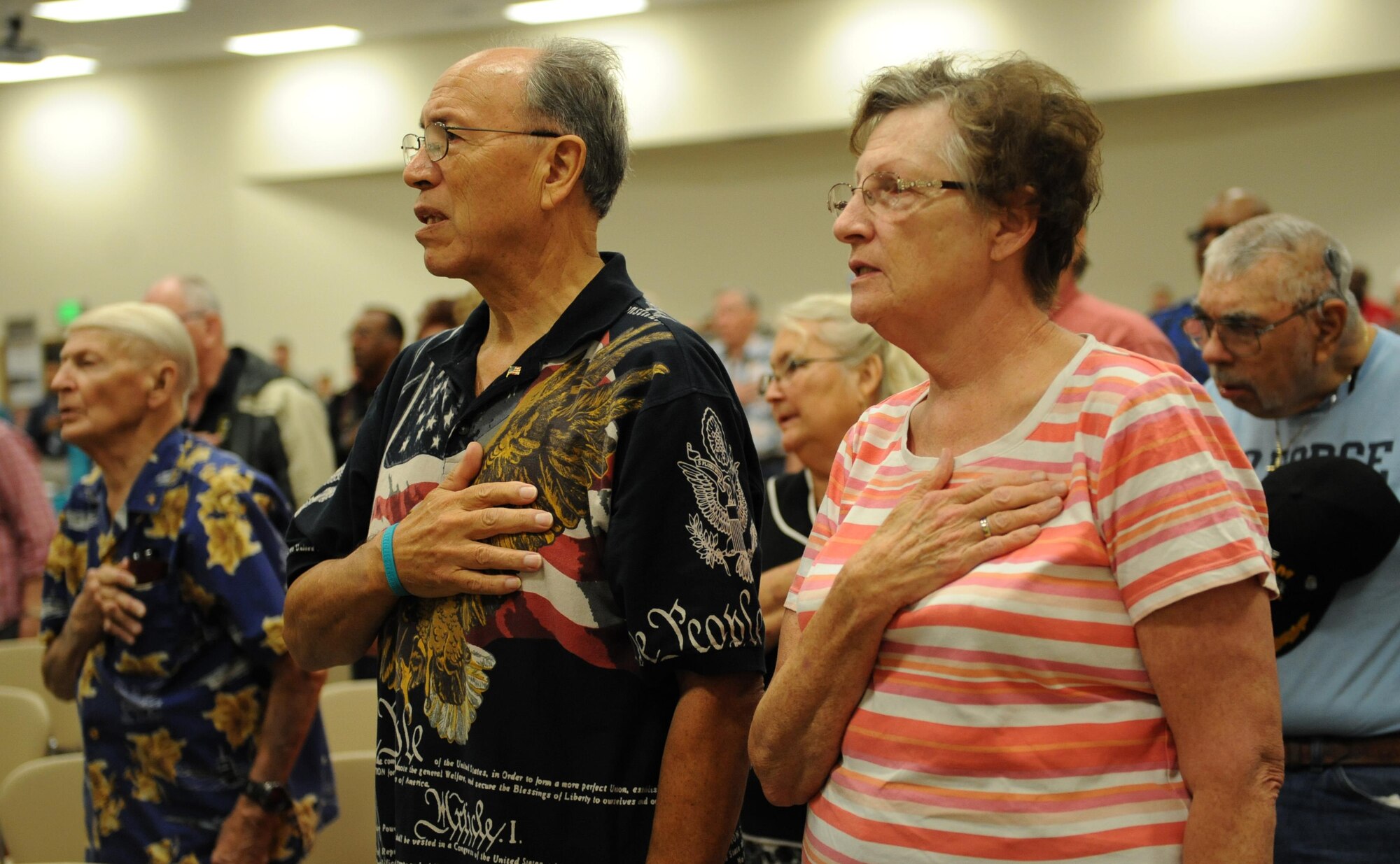 Retired Master Sgt. John Friday and his wife, Anne, recite the Pledge of Allegiance during Retiree Appreciation Day at the Roberts Consolidated Aircraft Maintenance Facility Nov. 6, 2015, Keesler Air Force Base, Miss.  The annual event sponsored by the Keesler Retiree office included more than 20 displays with information pertinent to retirees and a free lunch.  (U.S. Air Force photo by Kemberly Groue)