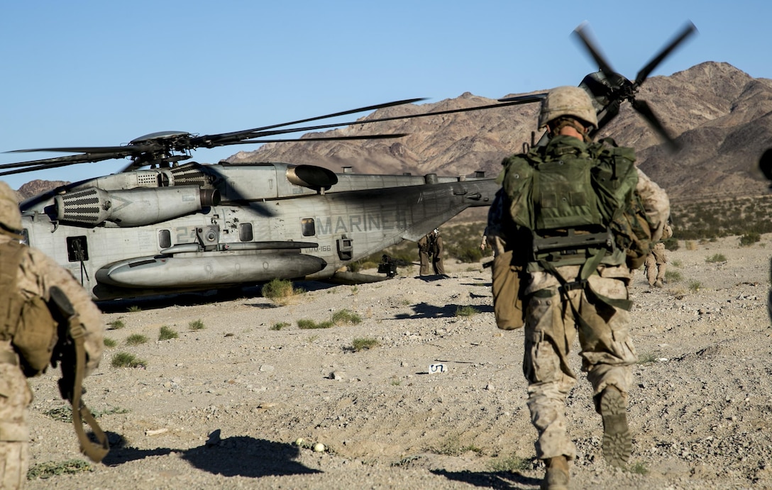 Marines load onto a Marine Corps CH-53 helicopter at the evacuation site of a raid operation during a composite exercise on Marine Corps Air Ground Combat Center, Twentynine Palms, Calif., Oct. 30, 2015. U.S. Marine Corps photo by Cpl. Briauna Birl