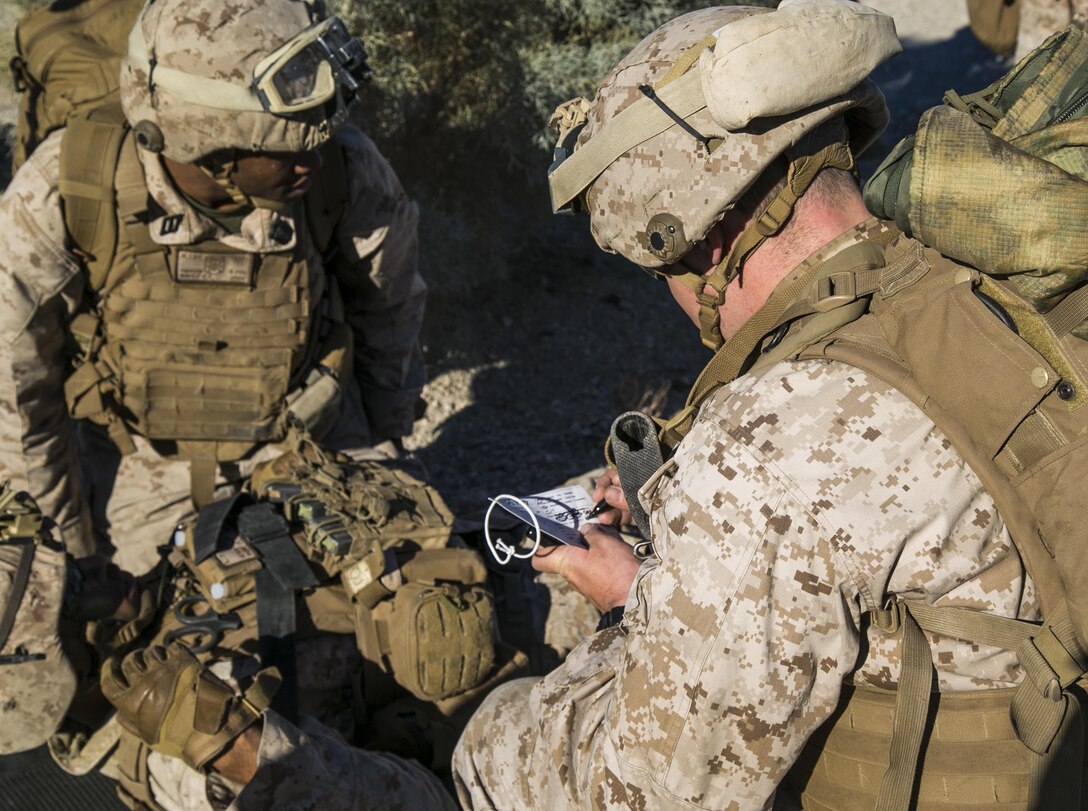 Marines and sailors assess a simulated casualty after conducting a raid on a hostile village during a composite exercise on Marine Corps Air Ground Combat Center Twentynine Palms, Calif., Oct. 30, 2015. U.S. Marine Corps photo by Cpl. Briauna Birl