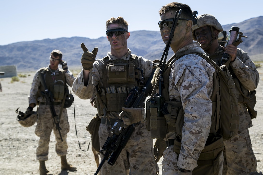 Marines discuss strategy before conducting a raid on a simulated hostile village to search for high-value targets during a composite exercise on Marine Corps Air Ground Combat Center Twentynine Palms, Calif., Oct. 30, 2015. U.S. Marine Corps photo by Cpl. Briauna Birl