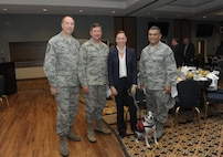 Chief Master Sgt. Robert Boyer (left), 19th Air Force command chief, Maj. Gen. Leonard Patrick, Air Education Training  Command vice commander, Molly Mae Potter, wounded warrior, her dog Bella and Chief Master Sgt. Gerardo Tapia (right), AETC command chief, attend the Wounded Warrior Combat Breakfast Nov. 3, 2015 at Joint Base San Antonio-Randolph.  This annual breakfast features a tribute to the wounded service members who have put themselves in harms way in defense of the freedom. (U.S. Air Force photo by Joel Martinez/Released)