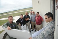 Maj. Jason Powell (left), 12th Flying Training Wing safety officer, briefs San Antonio air traffic controllers on the potential of bird strikes on aircraft during their tour at Joint Base San Antonio-Randolph Nov. 6, 2015. Air Traffic Controllers are responsible for directing aircraft safety, including keeping aircraft a safe distance apart, advises on landing and alerts pilots to potential problems. (U.S. Air Force photo by Joel Martinez/Released).
