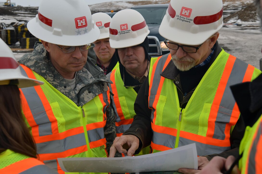 TOLNA, N.D. – Bill Csajko, St. Paul District project engineer, right, briefs Maj. Gen. John Peabody, Mississippi Valley Division commander, on the Tolna Coulee control structure Jan. 30. 