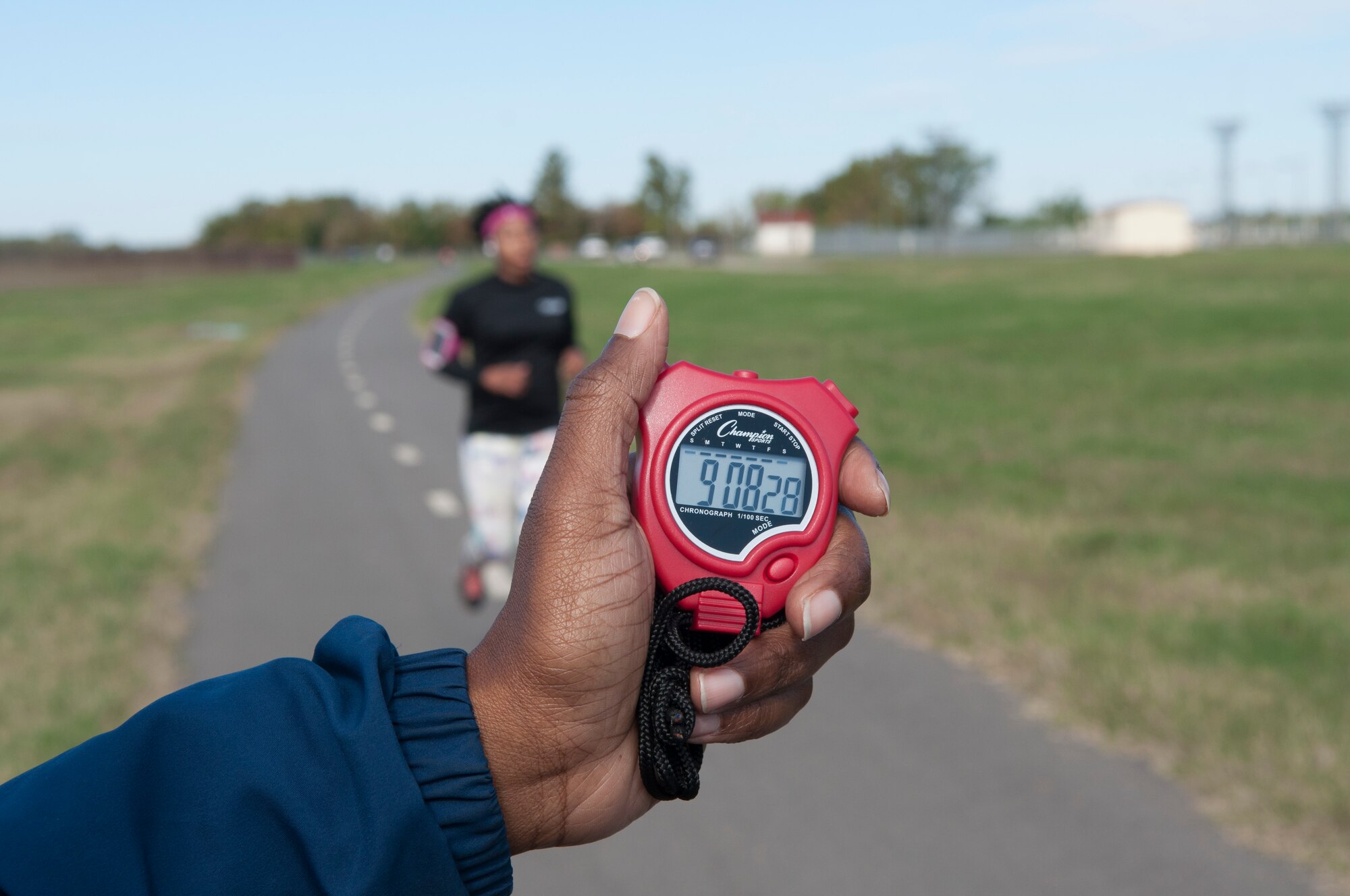 Time ticks away as runners of the U.S. Air Force Reserve 307th Bomb Wing make their way through the 307th BW Turkey Trot 5K at Barksdale Air Force Base, La., Nov. 8, 2015. The winners of this race were awarded turkeys in time for Thanksgiving.  (U.S. Air Force photo by Senior Airman Callie Ware/ Released)