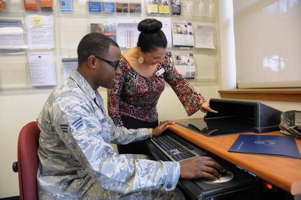 Amanda Jalomo, Joint Base San Antonio-Randolph Education Center education specialist, helps Senior Airman Princeton Blanchard, Air Force Personnel Center, search for educational information during the Virtual Education Fair at the Joint Base San Antonio-Randolph Education Center Nov. 4, 2015.  Virtual Education Fairs, help students search for schools, meet education career needs, live chat with representatives from participating schools and give financial aid options.  (U.S. Air Force photo by Joel Martinez/Released)