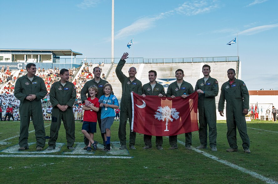 An Air Force Reserve aircrew consisting seven graduates of The Citadel flew over the Bulldogs Homecoming Military Classic of the South game against the Virginia Military Institute Keydets in Charleston, S.C. Nov. 7. The 701st Airlift Squadron “Turtles” flight crew performed the flyover of Johnson Hagood Stadium in a Joint Base Charleston C-17 Globemaster III as part of a local training mission. (U.S. Air Force photo by Staff Sgt. Bobby Pilch)