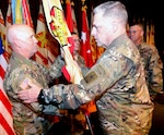 Lt. Gen. Kenneth R. Dahl (left) receives the unit flag from Chief of Staff of the Army Gen. Mark A. Milley and becomes the new commanding general for U.S. Army Installation  Management Command at Fort Sam Houston Nov. 3. In the background at the ceremony in the Fort Sam Houston Theatre are IMCOM Command Sgt. Maj. Jeffrey Hartless (center) and Lt. Gen. David Halverson, the former IMCOM commander and current Assistant Chief of Staff for Installation Management.