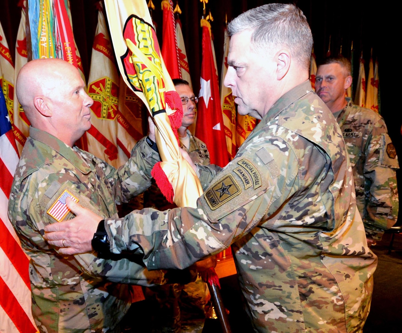 Lt. Gen. Kenneth R. Dahl (left) receives the unit flag from Chief of Staff of the Army Gen. Mark A. Milley and becomes the new commanding general for U.S. Army Installation  Management Command at Fort Sam Houston Nov. 3. In the background at the ceremony in the Fort Sam Houston Theatre are IMCOM Command Sgt. Maj. Jeffrey Hartless (center) and Lt. Gen. David Halverson, the former IMCOM commander and current Assistant Chief of Staff for Installation Management.