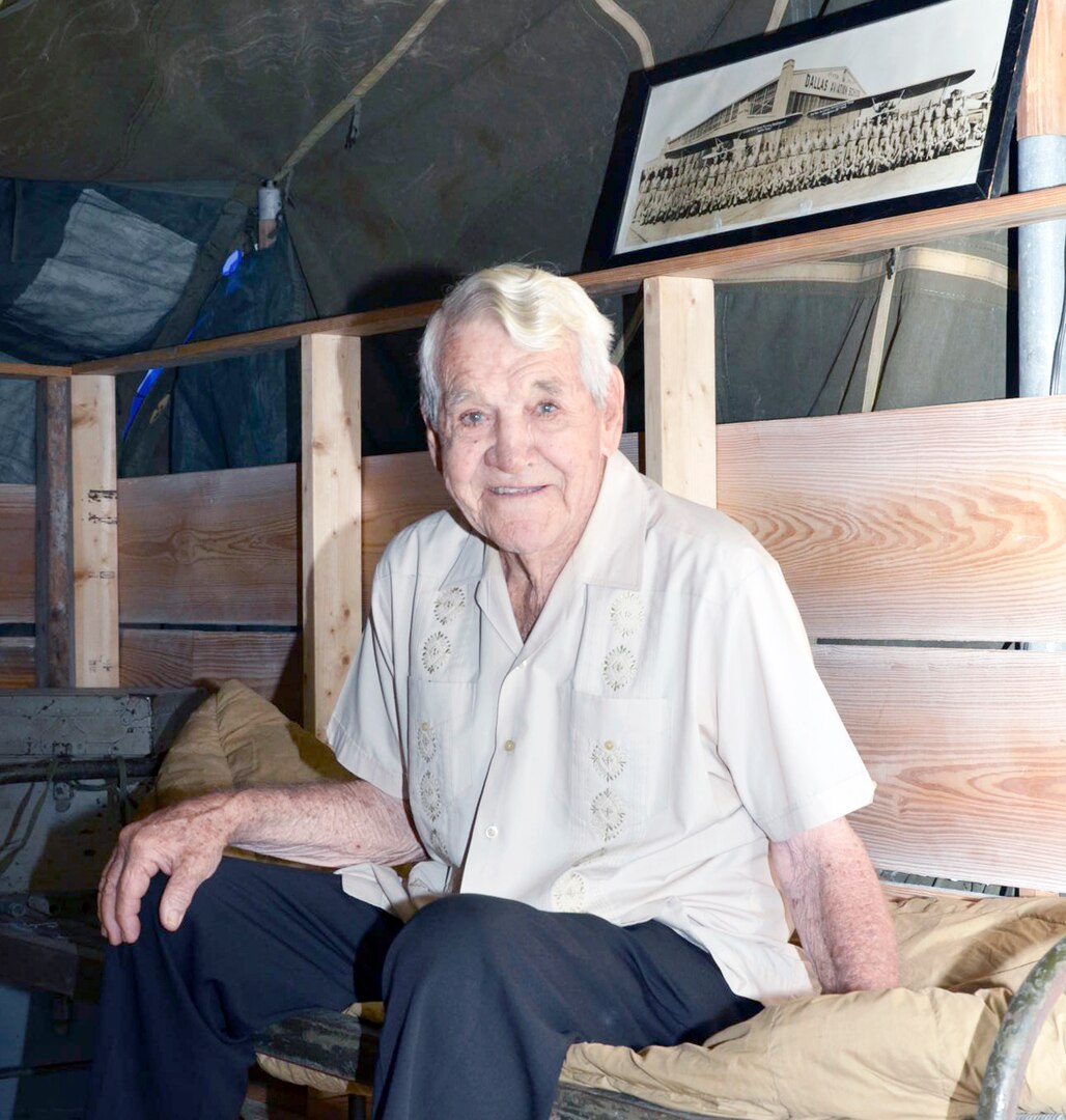 Colonel (Ret.) Robert “Buck” Inghram sits in a replica of a WWII bunker along with this flight school gradation photo. Ingram was one of three Americans to dig the Great Escape tunnels: Tom, Dick and during WWII from Stalag Luft German prison camp. US Air Force Photo