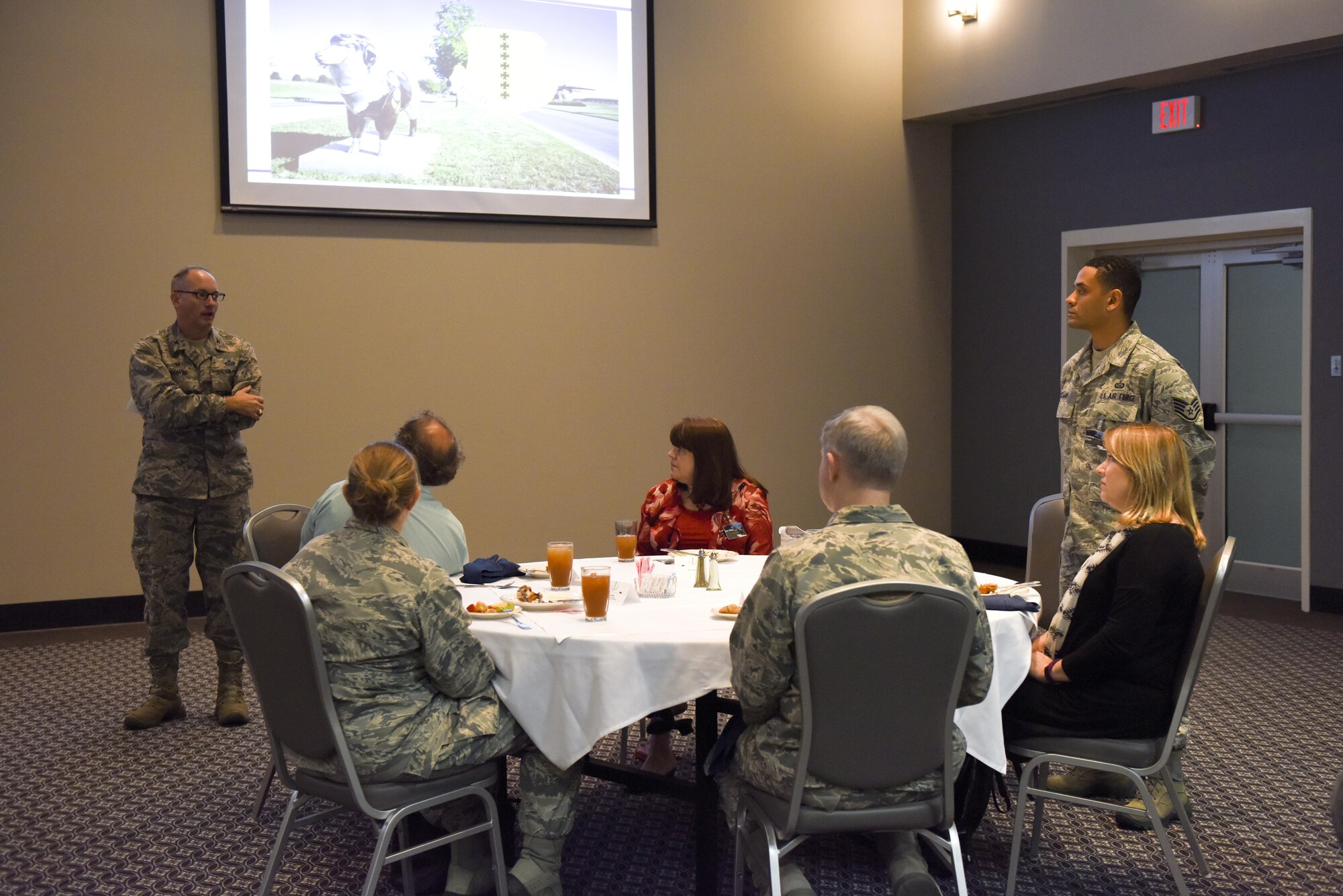 U.S. Air Force Col. Michael L. Downs, 17th Training Wing Commander, talks about Staff Sgt. Anthony Elijah, 315th Training Squadron instructor, during the Honorary Commanders Luncheon at the Event Center on Goodfellow Air Force Base, Texas, Nov. 5, 2015. Elijah returned from a deployment where he taught foreign nationals Ju-Jitsu. (U.S. Air Force photo by Airman Chase Sousa/Released)