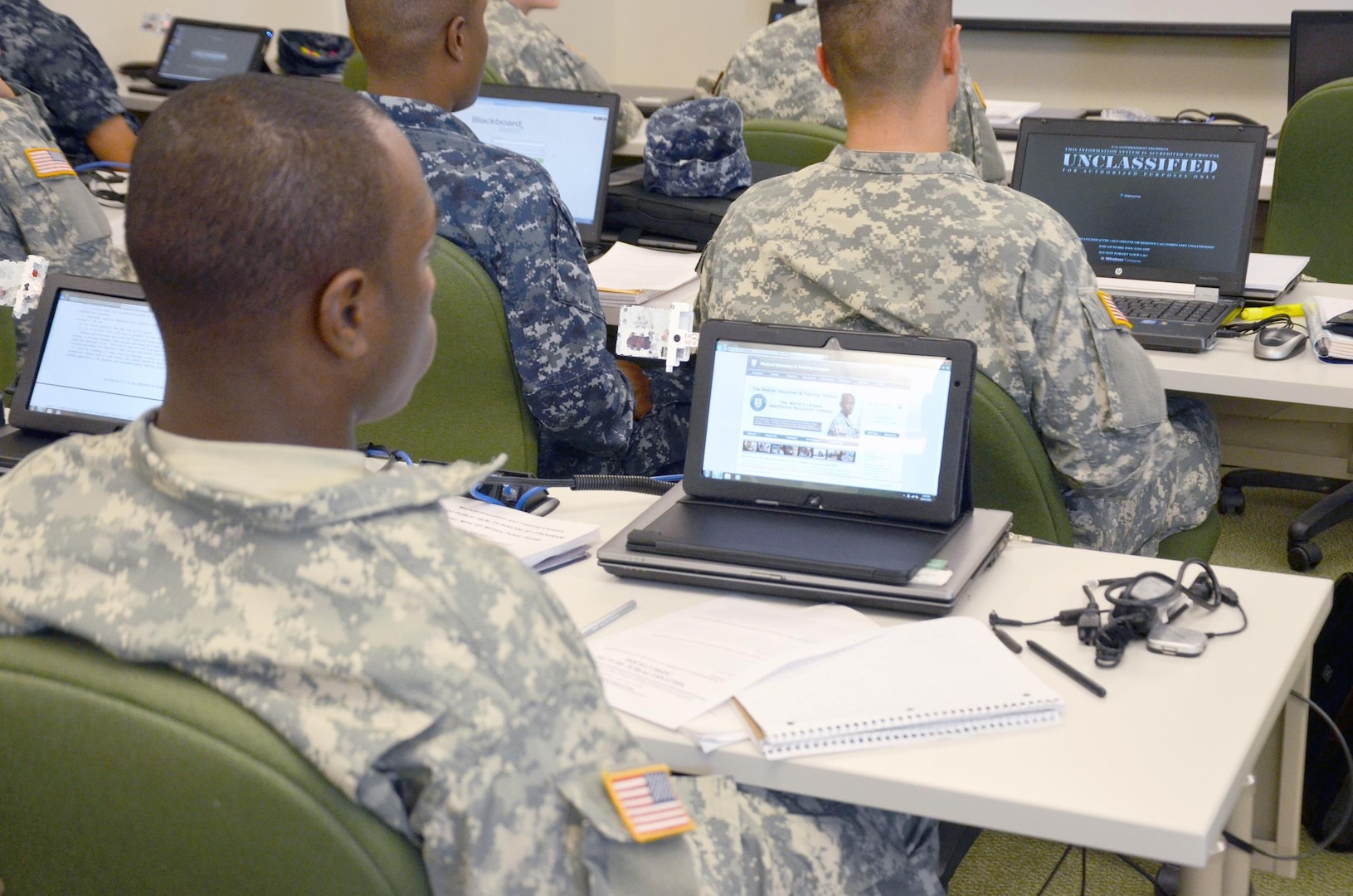 A student in the Public Health Specialist program, class 005-16, utilizes a Slate tablet in class as part of eMETC, a test pilot program. Two Public Health Specialist program classes were issued wireless laptops or Slates to test the feasibility of using mobile devices to enhance learning ability.