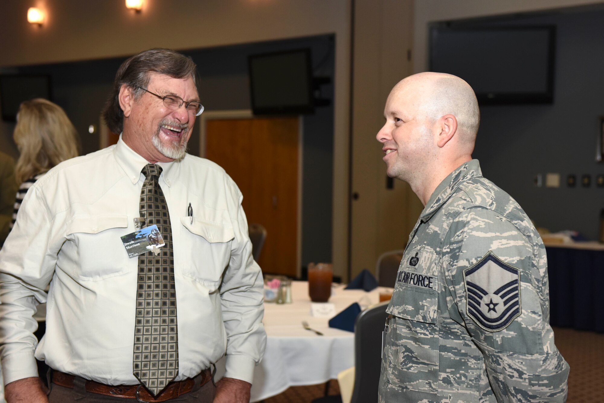 Dwain Morrison, San Angelo mayor, speaks to U.S. Air Force Master Sgt. Michael R. Glover, 17th Force Support Squadron Military Personnel Support superintendent, during the Honorary Commanders Luncheon at the Event Center on Goodfellow Air Force Base, Texas, Nov. 5, 2015. Glover recently returned from a deployment. (U.S. Air Force photo by Airman Chase Sousa/Released)