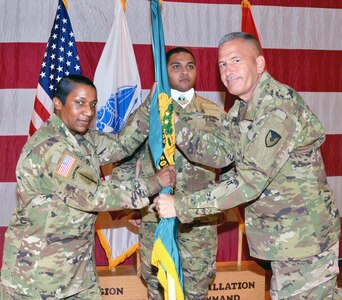 Command Sgt. Maj. Tomeka O’Neal (left) accepts the Mission and Installation Contracting Command colors from Brig. Gen. Jeffrey  Gabbert as color bearer Staff Sgt. Larry Taylor looks on during an  assumption of responsibility ceremony Nov. 3 at Fort Sam Houston. Gabbert is the MICC commanding general.