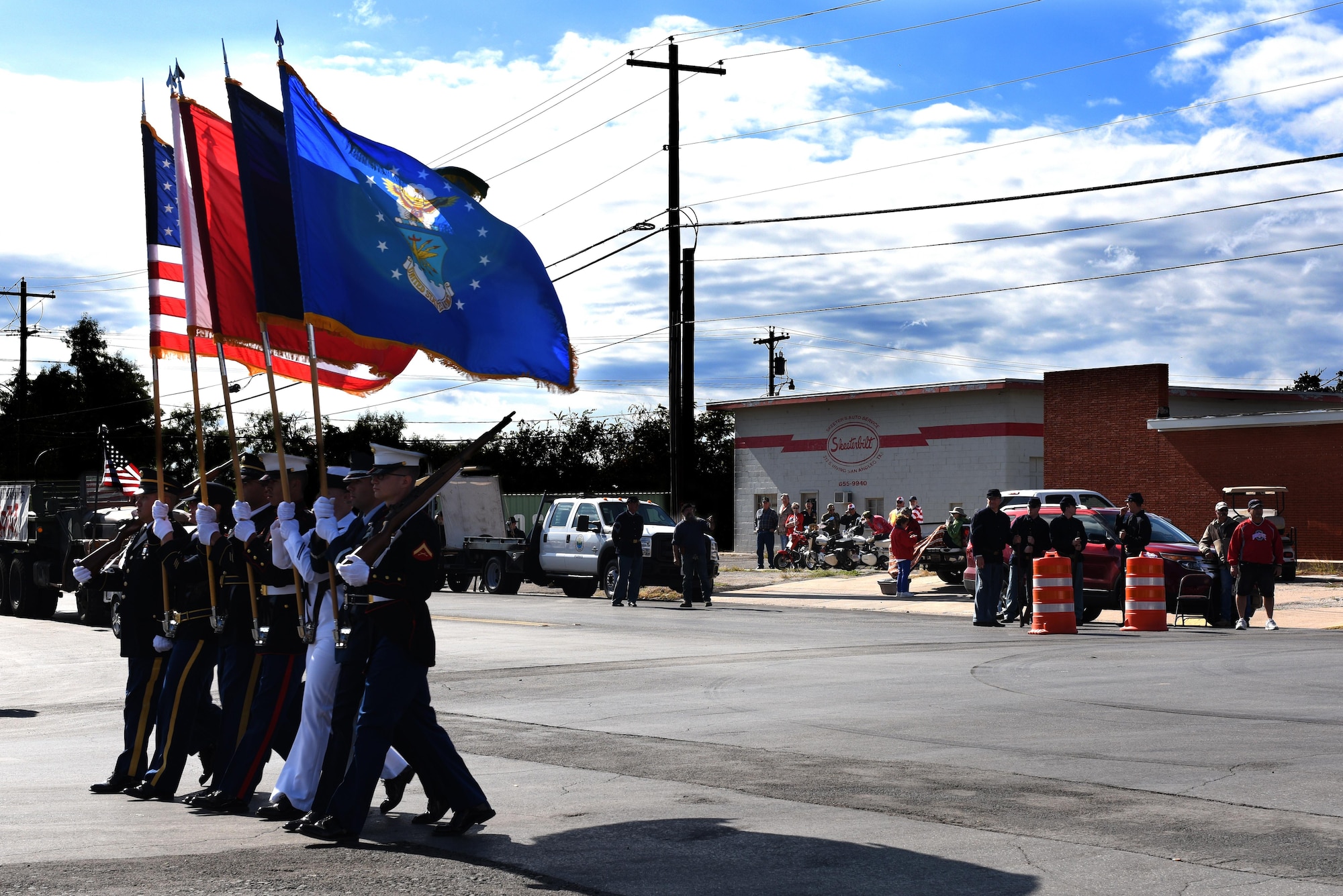 Goodfellow Air Force Base Joint Service Color Guard lead the Veterans Day Parade march in downtown San Angelo, Texas, Nov. 7, 2015. The parade featured floats and was a conglomeration of service members of all branches and volunteers from San Angelo. (U.S. Air Force photo by Airman Chas Sousa/Released)