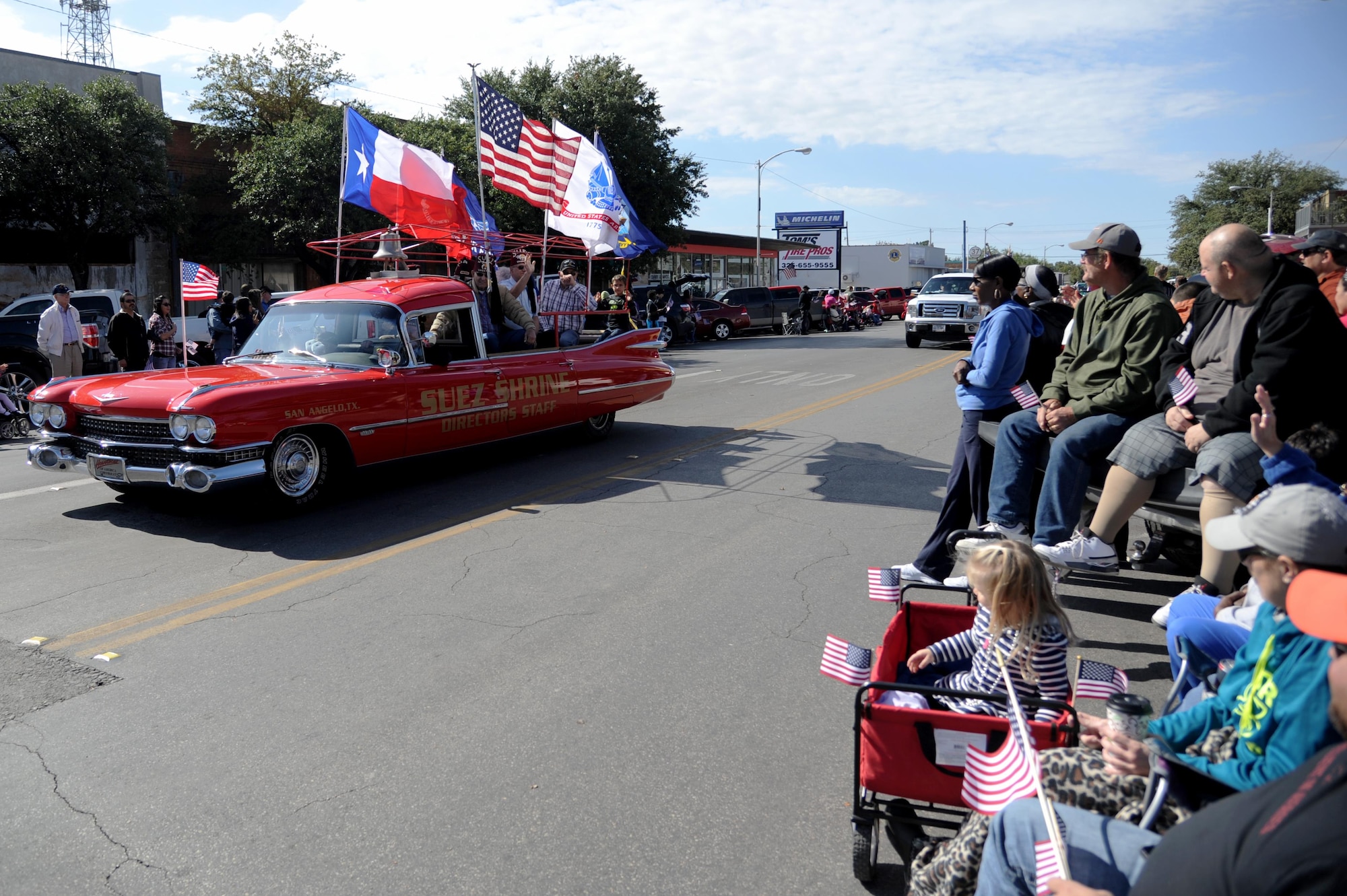 People watch as the San Angelo Suez Shrine passes them at the Veterans Day Parade in San Angelo, Texas, Nov. 7, 2015. This was the 12th time the Tom Green County’s All Veterans Council hosted the parade. (U.S. Air Force photo by Senior Airman Joshua Edwards/Released)