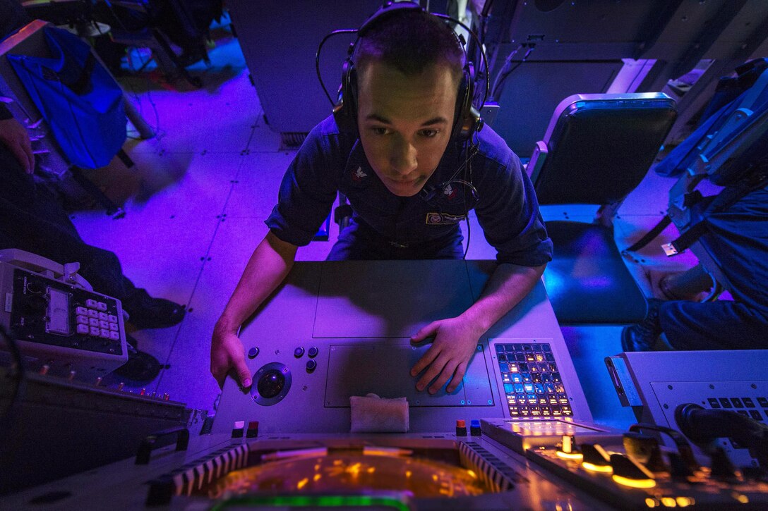 U.S. Navy Petty Officer 2nd Class Lance Simon monitors a radar console for air and surface contacts in the combat information center aboard the guided missile destroyer USS Stout in the Atlantic Ocean, Nov. 2, 2015. The destroyer is conducting routine training and operations to prepare for its upcoming deployment. U.S. Navy photo by Petty Officer 2nd Class Edward Guttierrez III