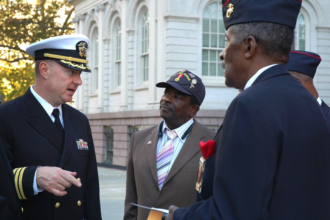 Navy Cmdr. Corey Barker, left, director of the Navy Office of Information East, talks with Navy and Marine veterans after an event in New York City, Nov. 4, 2015. The Mayor's Office of Veterans' Affairs is commemorating the first-ever posting of colors at City Hall to prepare for activities to honor veterans throughout the week. U.S. Navy photo by Petty Officer 3rd Class Carla Giglio
