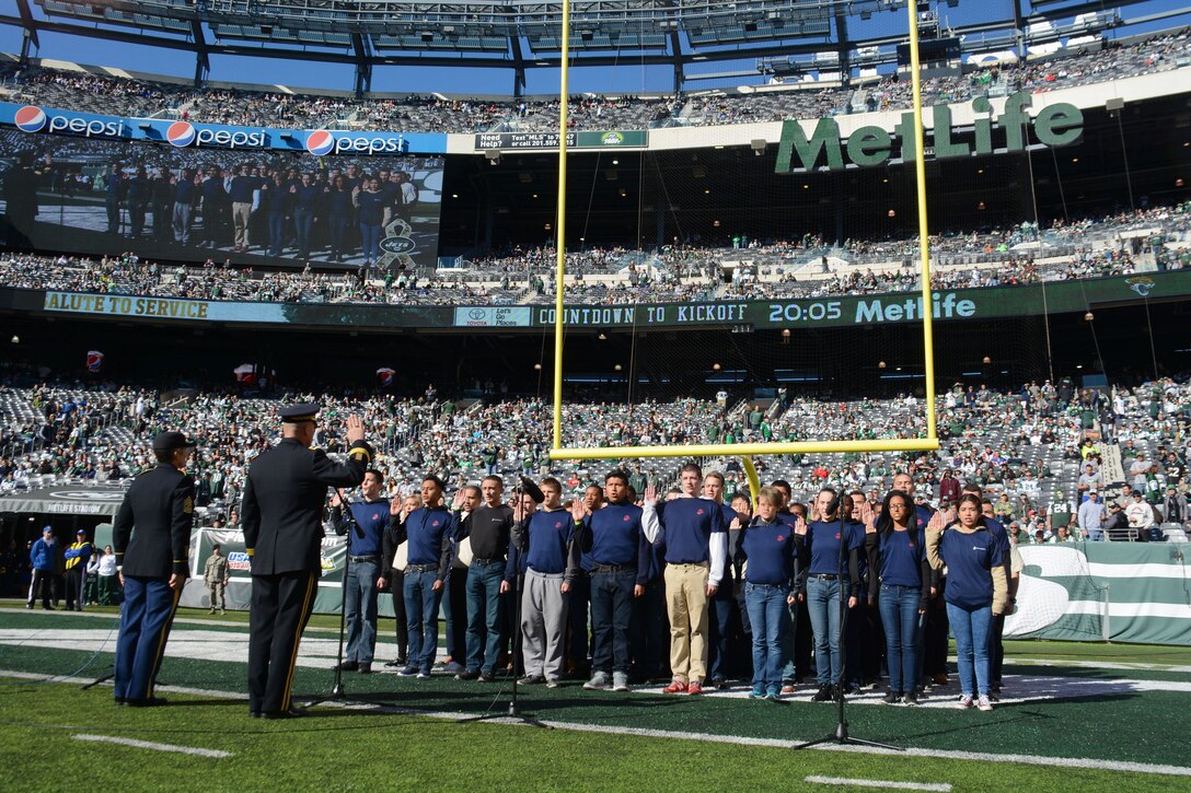 New recruits recite the oath of enlistment in front of fans at MetLife Stadium during a Veterans Day military appreciation game where the New York Jets hosted the Jacksonville Jaguars in East Rutherford, N.J., Nov 8, 2015. U.S. Navy photo by Petty Officer 1st Class Carlos M. Vazquez II