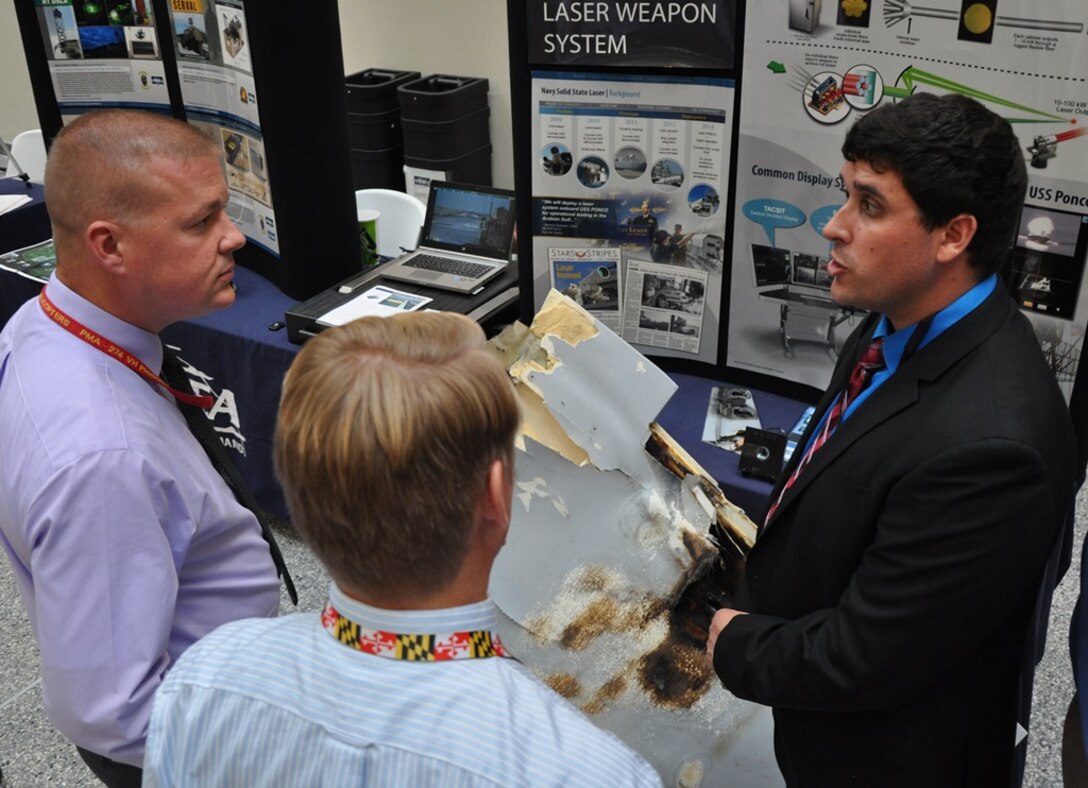 Cameron Sorlie, technical lead for the Navy's Laser Weapon System (LaWS), discusses high energy technologies at the Naval Surface Warfare Center Dahlgren Division (NSWCDD) Briefing and Technical Demonstration held at Naval Sea System Command (NAVSEA) headquarters, Nov. 3. "It's great to talk to NAVSEA leadership and provide additional details on the capabilities that the warfare labs provide," said Sorlie, a member of the LaWS engineering team that designed and developed the laser weapon system. The team installed and integrated LaWS aboard the deployed USS Ponce (AFSB(I) 15) while training the ship's Sailors on its operation. USS Ponce Sailors reported the weapon performed flawlessly, exceeding expectations for both reliability and maintainability, during June 2015 testing in the Arabian Gulf. 
