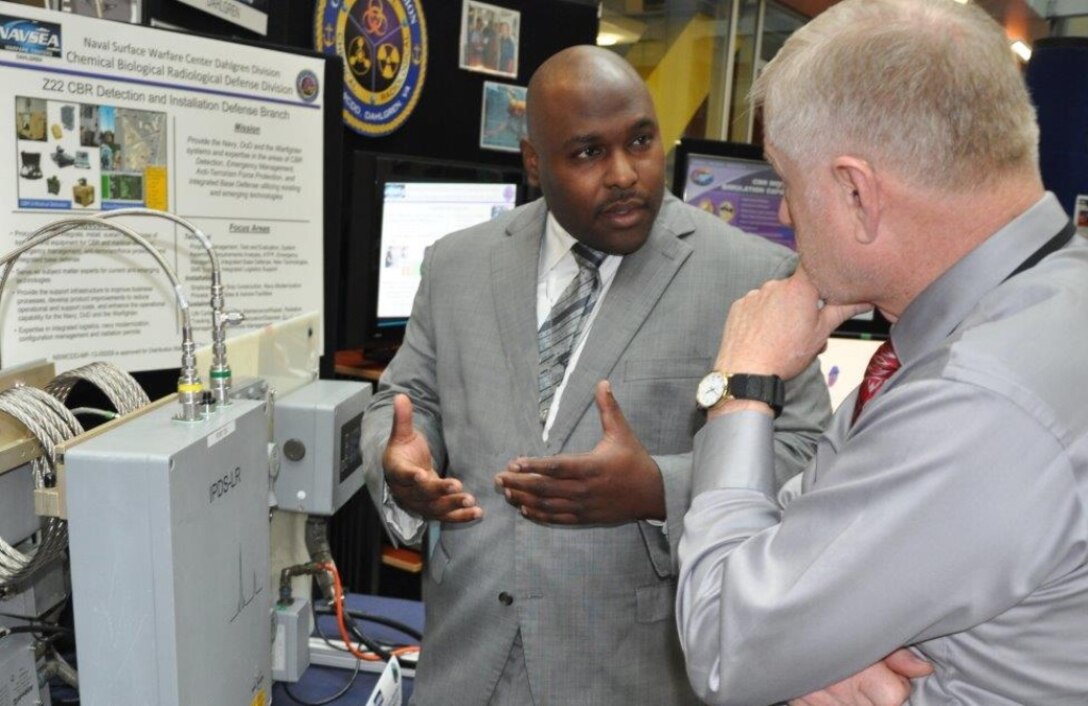Naval Surface Warfare Center Dahlgren Division (NSWCDD) chemist Tim Anthony explains the Navy's shipboard chemical warfare agent detector, called the Improved Point Detection System - Life cycle Replacement, at the NSWCDD Briefing and Technical Demonstration held at Naval Sea System Command headquarters, Nov. 3. The Navy has installed the system  - designed to quickly alert warfighters to the presence of chemical warfare agents - on 50% of all active guided missile destroyers and cruisers, aircraft carriers, large and small deck amphibious ships, littoral combat ships and dry cargo/ammunition ships with plans to be completed by the end of 2019.  