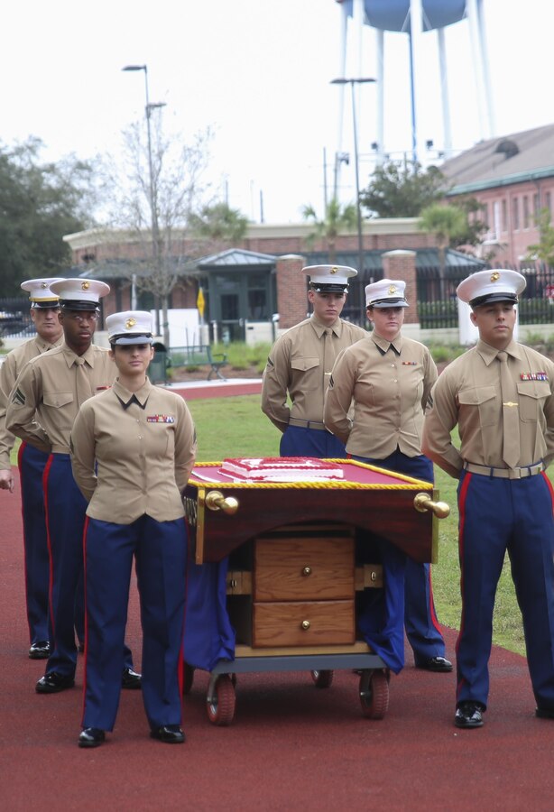 Marines with Marine Forces Reserve headquarters battalion stand by the ceremonial cake during the 240th Marine Corps birthday cake-cutting ceremony at Marine Corps Support Facility New Orleans, Nov. 10, 2015. The cake-cutting ceremony is a tradition through the Marine Corps, in which the first piece of cake is passed from the oldest Marine to the youngest Marine present, symbolizing the passing of traditions and knowledge from one generation of Marines onto the next. (U.S Marine Corps photo by Lance Cpl. Devan Barnett)