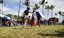 Kapuaikaula Makahiki event-goers participate in hakamoa, a one-legged wrestling competition during JBPHH's annual Makahiki event, held Nov. 7, 2015, at Hickam Harbor Beach on Joint Base Pearl Harbor-Hickam. The Makahiki, known as a "Hawaiian Thanksgiving," provided an opportunity for military families to appreciate and learn more about the culture and history of Hawaii. (U.S. Air Force photo by Staff Sgt. Christopher Stoltz/Released)
