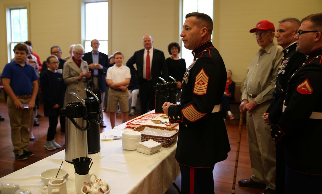 Sgt. Maj. Anthony Spadaro, sergeant major for Marine Forces Reserve and Marine Forces North, explains the importance of the cake cutting tradition on the Marine Corps birthday to parishioners and guests of Grace Episcopal Church in St. Francisville, La., Nov. 10, 2015.  The Marines of MarForRes held a cake cutting ceremony following a wreath-laying ceremony to honor Gen. Robert H. Barrow, 27th Commandant of the Marine Corps and native of St. Francisville. 