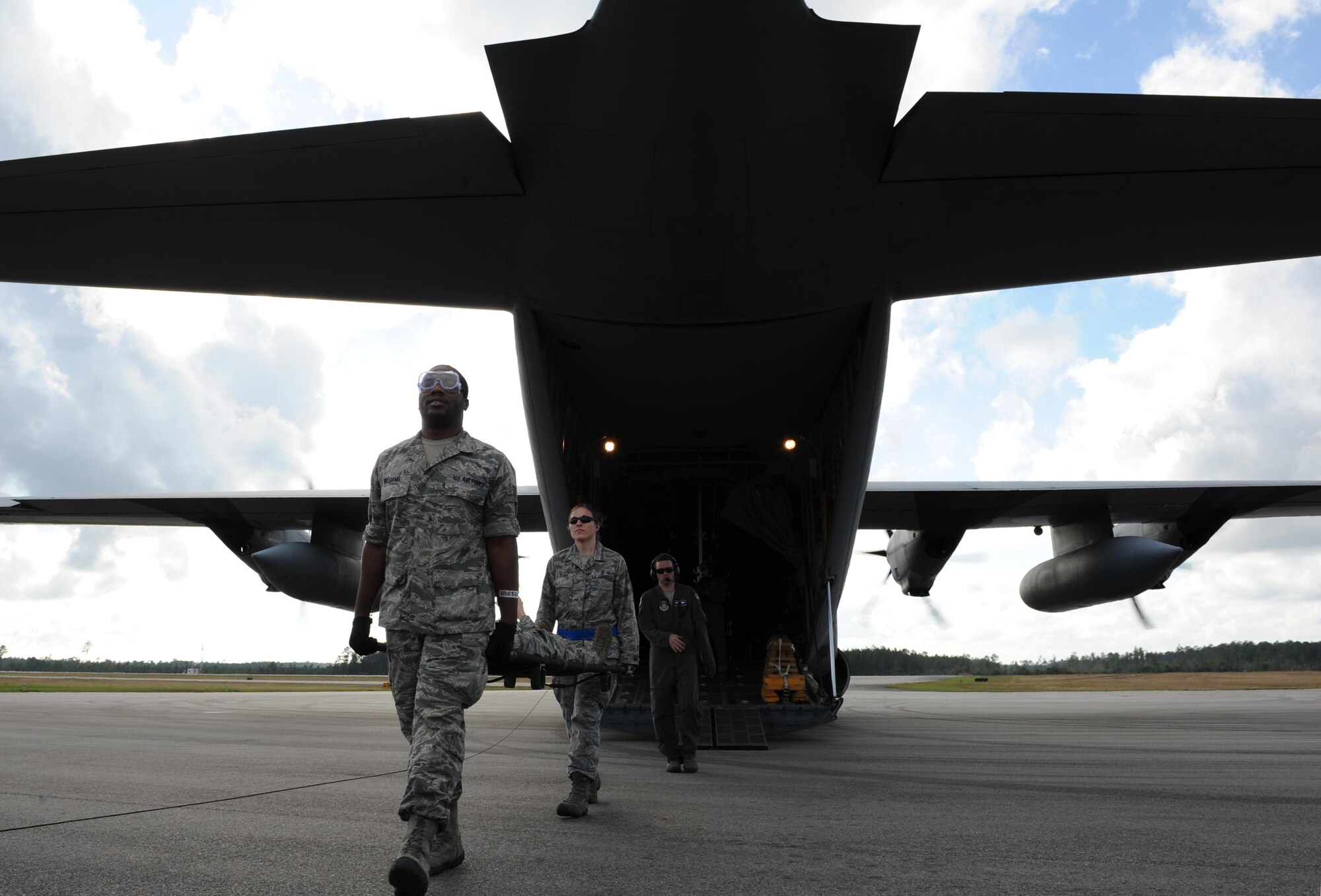 Senior Airman Jarrett Williams, 81st Aerospace Medicine Squadron medical technician, and 1st Lt. Jennifer Andrews, 81st AMDS nurse manager, Keesler Air Force Base, Miss., carry a patient off of a C-130J aircraft during the Mississippi National Guard’s annual Southern Strike training at Stennis International Airport Nov. 5, 2015, Miss. Members of the 81st Medical Group assisted with aircraft engine running on- and off-loading. The two-week joint international combat exercise was hosted by the Mississippi National Guard and included service members from both active and reserve components in every branch of the U.S. military service. (U.S. Air Force photo by Kemberly Groue)