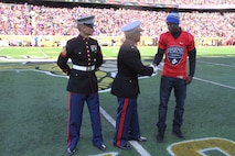 Major Christopher Tsirlis shakes hands with Tyler Johnson, who was selected to play in the Semper Fi All American Bowl in 2016, while Sgt. Kyle Henderson looks on, at the MN Vikings game, November 8. Additionally, the Silent Drill Platoon performed at half-time. 
