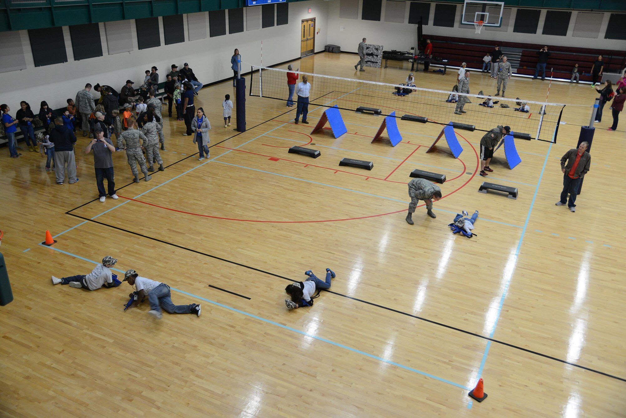 Military and local children complete an obstacle course at the Losano Fitness Center on Laughlin Air Force Base, Texas, Nov. 7, 2015. The mock deployment included various activities such as, out-processing with base agencies, learning basic customs and courtesies, obstacle courses and more. (U.S. Air Force photo by Airman 1st Class Ariel D. Partlow)