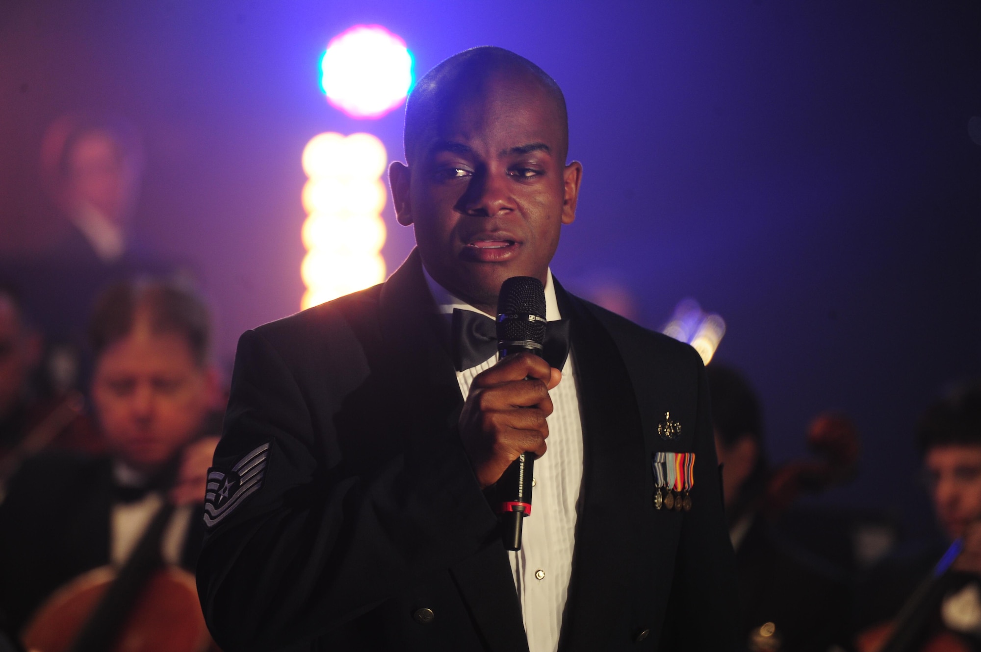 Tech. Sgt. Aaron Paige, a U.S. Air Force Band vocalist, sings a solo performance at the Maryland Public Television studio during a live recording of the band’s Veterans Day tribute compositions in Owings Mills, Md., Nov. 06, 2015. Paige is a member of the Singing Sergeants, a vocal ensemble of the band. (U.S. Air Force photo/Senior Airman Joshua R. M. Dewberry)