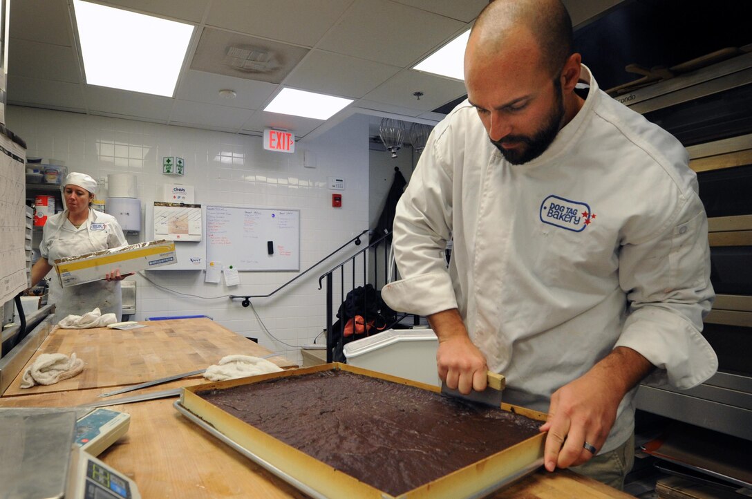 Army veteran Josh Tredinnick bakes in the Dog Tag Bakery, Washington, D.C., Oct. 19, 2015.  The Dog Tag Bakery is operated by the administration and faculty of Georgetown University’s School of Continuing Studies and helps rehabilitate disabled veterans by training them in the art of baking. DoD photo by Marvin Lynchard