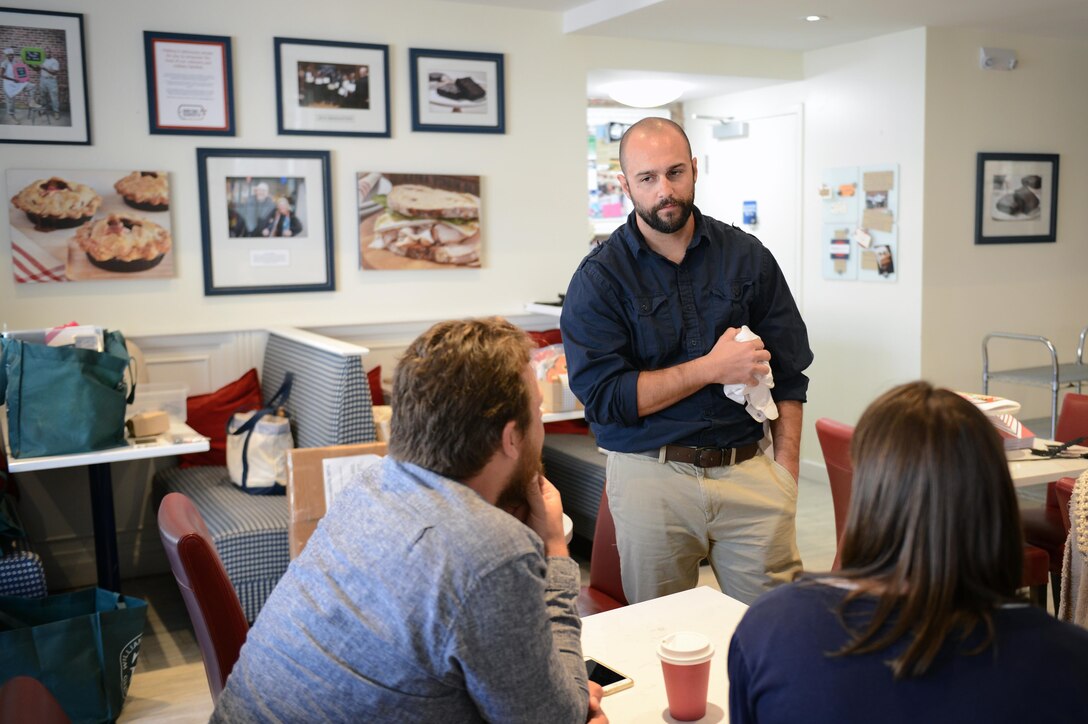 Army veteran Josh Tredinnick speaks to customers in the Dog Tag Bakery, Washington, D.C., Oct. 19, 2015. The Dog Tag Bakery is operated by the administration and faculty of Georgetown University’s School of Continuing Studies and helps rehabilitate disabled veterans by training them in the art of baking. DoD photo by Marvin Lynchard