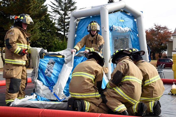 U.S. Air Force Airmen assemble a decontamination chamber during an exercise at Misawa Air Base, Japan, Nov. 3, 2015. Exercise Vigilant Ace 16 prompted the scenario of a suspicious package at the post office, setting off the response of emergency agencies on base. Individuals at the scene were cleansed of any potential chemical remains. 