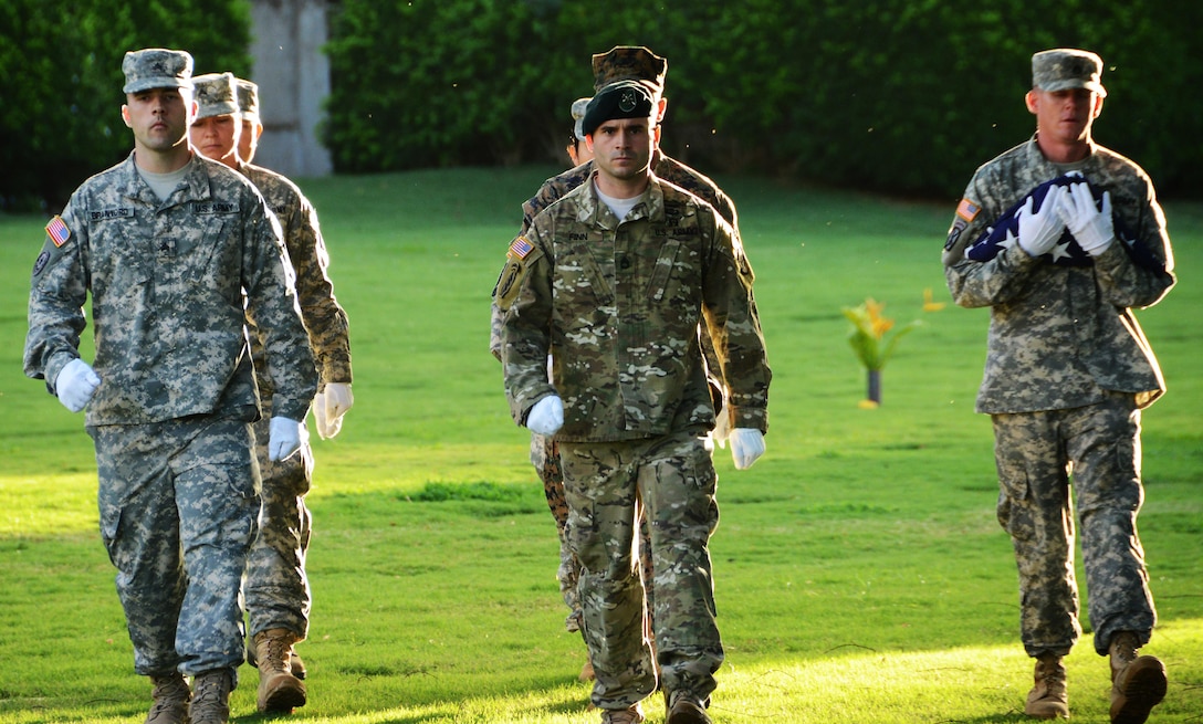 U.S. service members from the Defense POW/MIA Accounting Agency (DPAA) participate in a disinterment ceremony, Nov. 9, 2015, at the National Memorial Cemetery of the Pacific, Honolulu. DPAA holds these ceremonies to give honor and respect to our nation's unidentified dead before they are moved to the DPAA Lab for identification. The remains being disinterred are unknowns from the USS Oklahoma, lost from the attack on Pearl Harbor during WWII. These are the last of the USS Oklahoma to be disinterred. The mission of DPAA is to provide the fullest possible accounting for our missing personnel to their families and the nation. (DOD photo by Spc. Crystal D. Madriz)