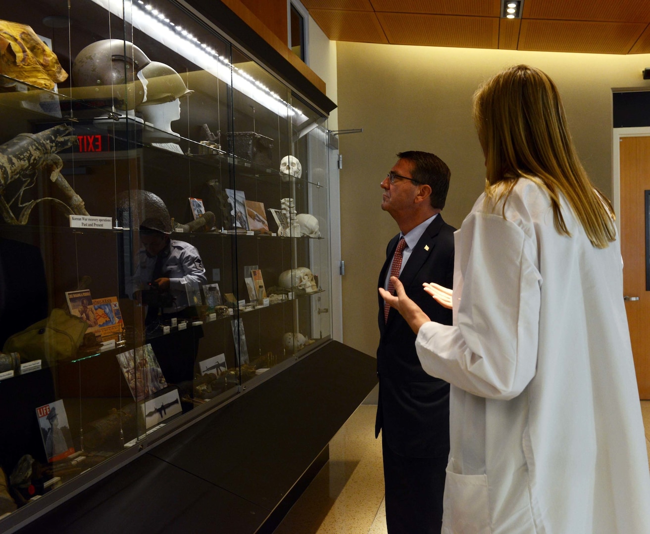 Dr. Debra Zinni, Defense POW/MIA Accounting Agency forensic anthropologist, speaks about artifacts stored in the DPAA laboratory with Secretary of Defense Ash Carter. While at DPAA, he spoke with service members about the importance of the agency's joint mission in the Indo-Asia Pacific region. The mission of the Defense POW/MIA Accounting Agency is to provide the fullest possible accounting for our missing personnel to their families and the nation. (U.S. Air Force photo by Staff Sgt. La'Shanette Garrett)