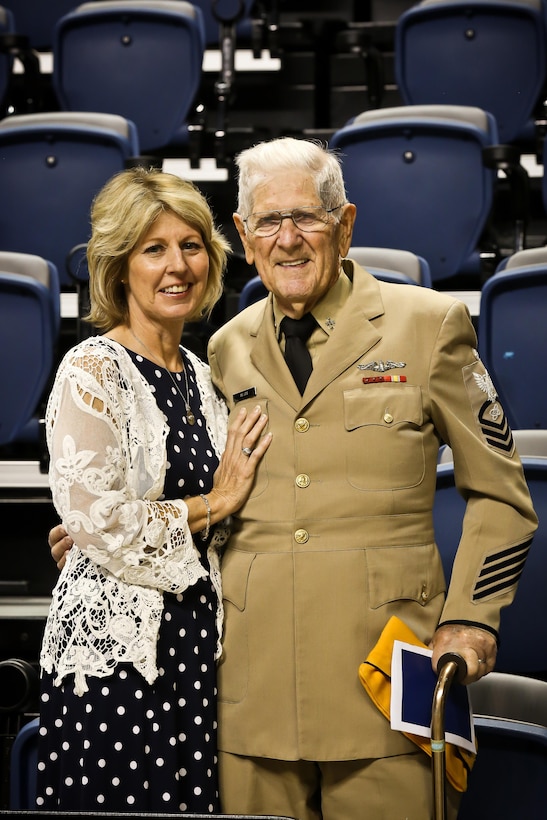 Diane Rogers Calhoun, of Hixson, Tenn., stands next to her father, retired Navy Senior Chief Electronics Technician Lee Rogers, at a memorial service for service members held Aug. 15, 2015, at the McKenzie Arena in Chattanooga.