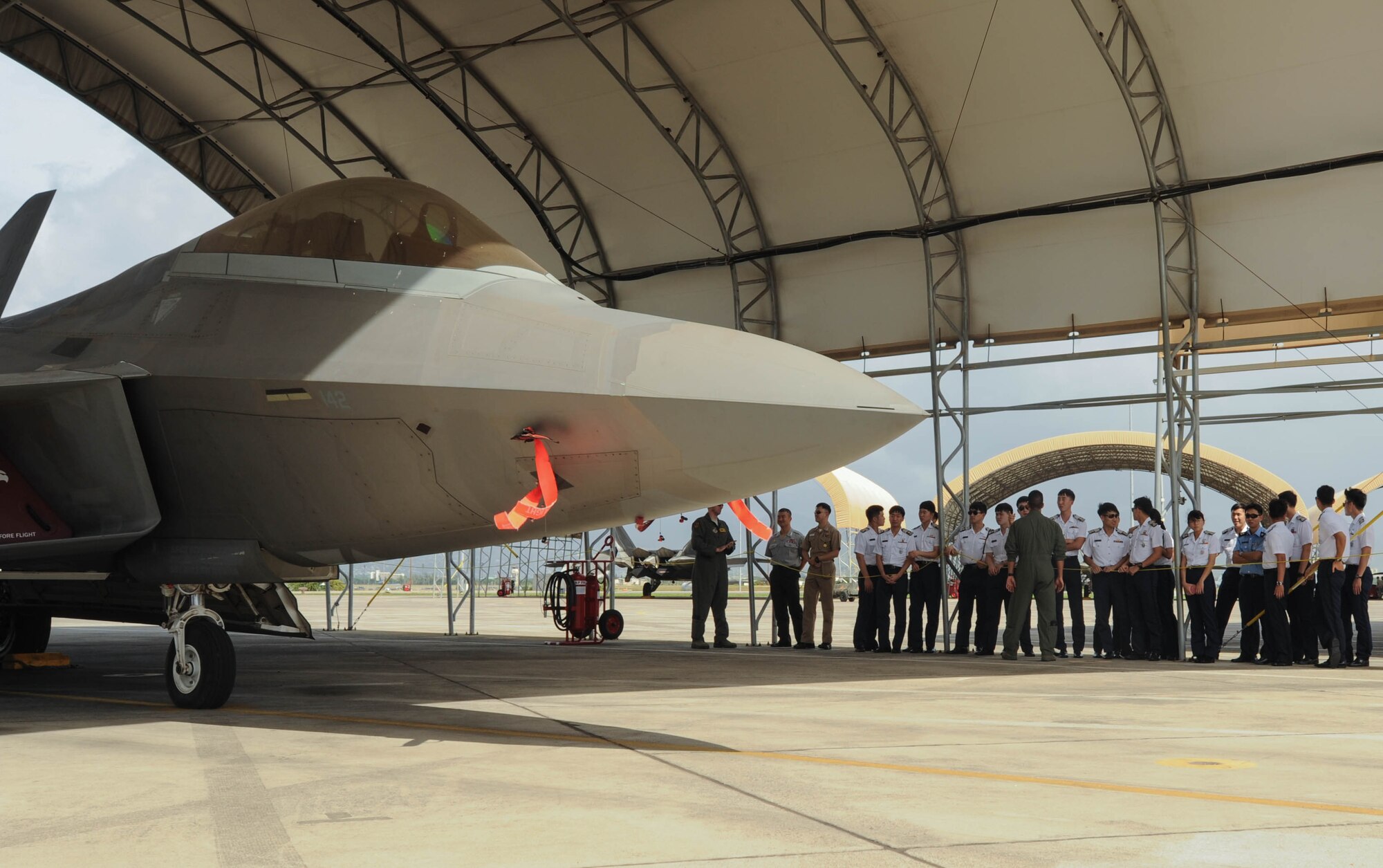 U.S. Air Force Capt. Jared Fujii, Hawaiian Raptors pilot, talks with Republic of Korea Air Force Academy cadets, Nov. 10, 2015, Joint Base Pearl Harbor-Hickam, Hawaii. The cadets’ visit was part of an effort to build a foundation of partnership and interoperability between Headquarters Pacific Air Forces and future ROKAF leaders. (U.S. Air Force photo by Tech. Sgt. Amanda Dick/Released)