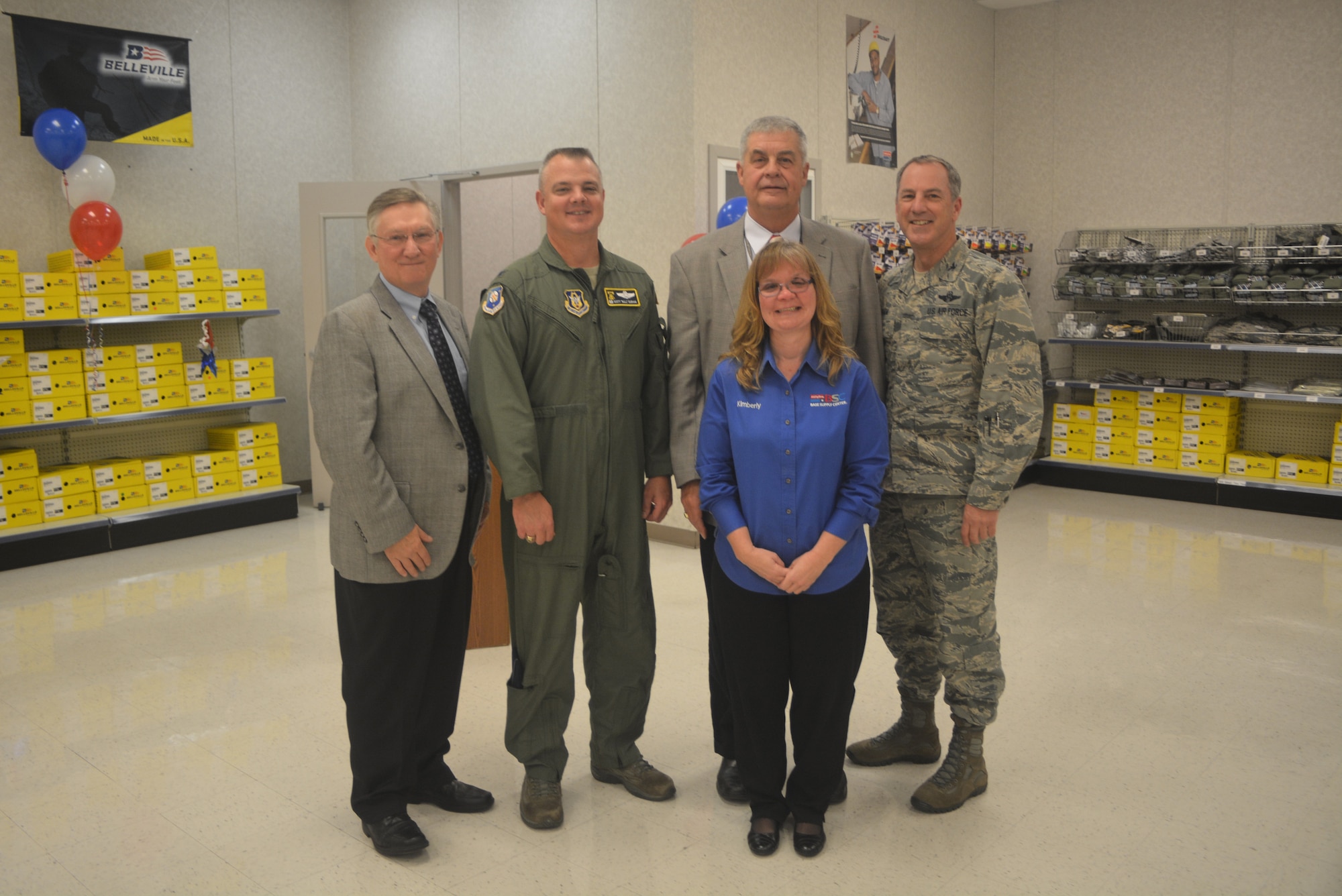 Kim Utley (center), stands with the commander and vice commander of the 512th Airlift Wing as well two representatives from the Blind Industries and Services of Maryland. Utley, the store manager for the Dover Air Force Base Ability One Base Supply Center, was recognized for her efforts at the Dover BSC,  which employs 26 blind and low vision employees. (U.S. Air Force photo/Master Sgt. Veronica Aceveda)