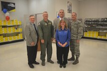 Kim Utley (center), stands with the commander and vice commander of the 512th Airlift Wing as well two representatives from the Blind Industries and Services of Maryland. Utley, the store manager for the Dover Air Force Base Ability One Base Supply Center, was recognized for her efforts at the Dover BSC,  which employs 26 blind and low vision employees. (U.S. Air Force photo/Master Sgt. Veronica Aceveda)