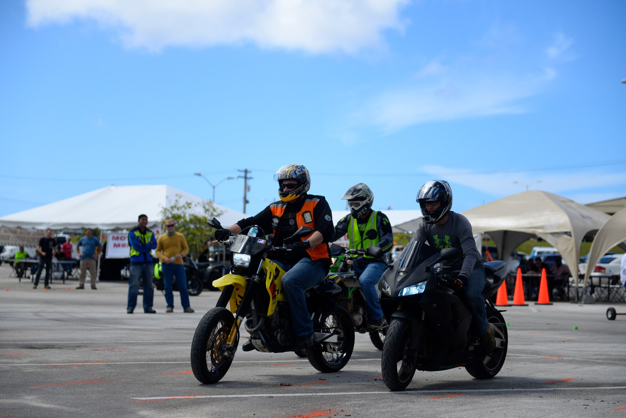 Riders compete during a slow-ride challenge Nov. 6, 2015, at Naval Base Guam. Military motorcyclists and family members practiced safe riding techniques, to include controlling their vehicle with throttle control, during a motorcycle mentorship day. (U.S. Air Force photo by Staff Sgt. Alexander W. Riedel/Released)