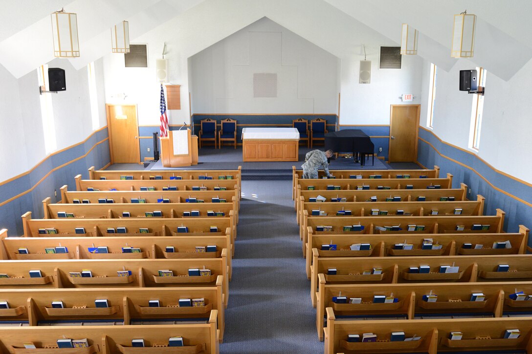 Staff Sgt. Daniel Wyn, 56th Fighter Wing chaplain assistant, arranges Bibles in the pews at Luke Air Force Base, Arizona, Nov. 9, 2015. Spirituality is one of the four pillars of Comprehensive Airman Fitness. Spiritual fitness is about having a sense of purpose and meaning in your life. (U.S. Air Force photo by Senior Airman James Hensley)
