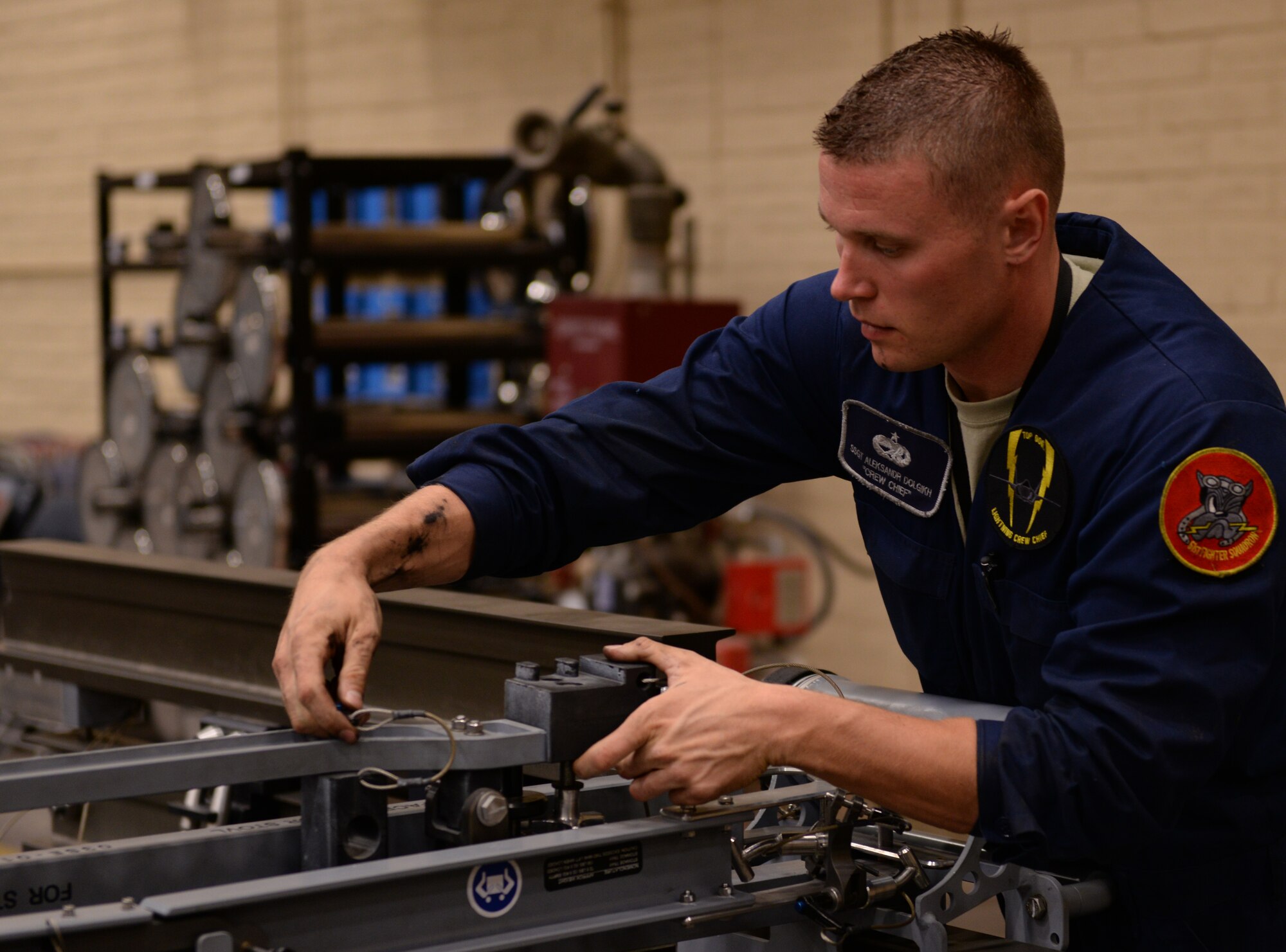 Staff Sgt. Aleksandr Dolgikh, 61st Aircraft Maintenance Unit crew chief, works with equipment designed to help dismantle F-35 components. The 61st work in conjunction with Detachment 12 of the 372nd Training Squadron to train Hill Air Force Base maintainers who are sent here to learn the skills necessary to allow them to maintain F-35s upon their return. (U.S. Air Force photo by Airman 1st Class Ridge Shan)