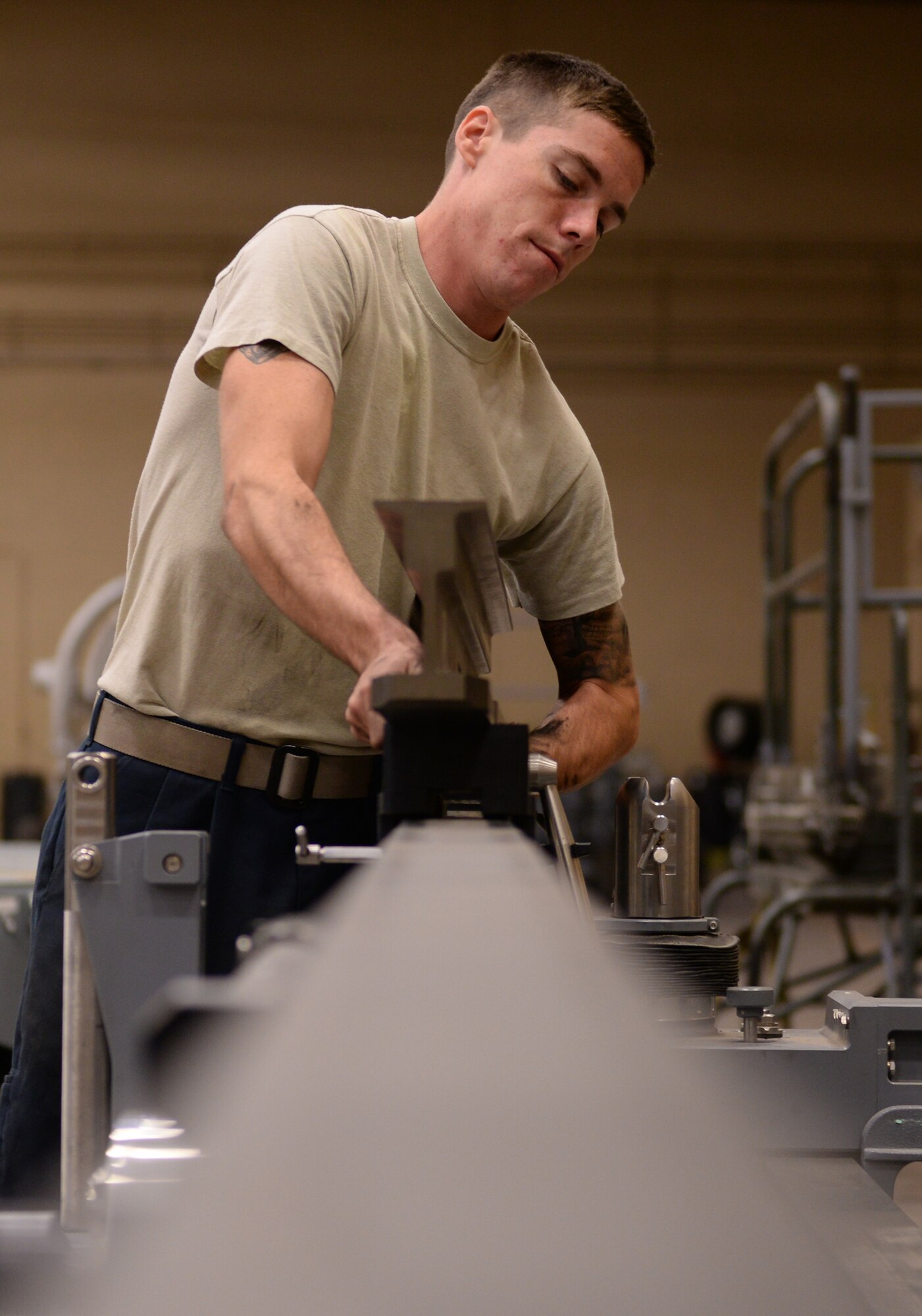 Senior Airman Roger Combs, 61st Aircraft Maintenance Unit maintainer, works with equipment designed to help dismantle F-35 components. The 61st AMU handles the hands-on practice phase of the training that some Hill Air Force Base maintainers undergo at Luke. (U.S. Air Force photo by Airman 1st Class Ridge Shan)