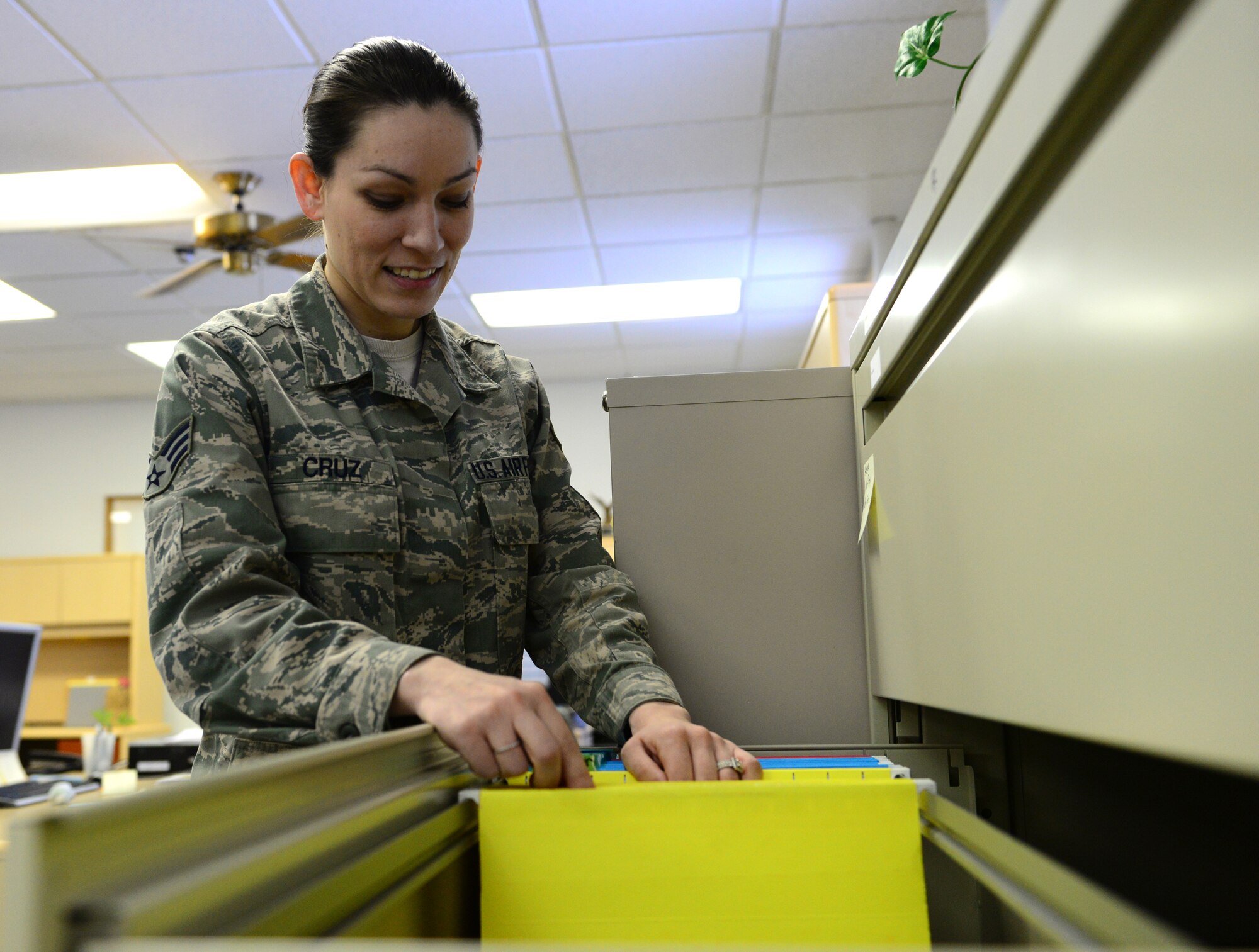 U.S. Air Force Senior Airman Tiffinie Cruz, a 354th Comptroller Squadron budget analyst and separation technician, files contracts Nov. 9, 2015, at Eielson Air Force Base, Alaska. Paper contracts are being replaced by digital contracts, making hand copy filing a thing of the past. (U.S. Air Force photo by Airman 1st Class Cassandra Whitman/Released)