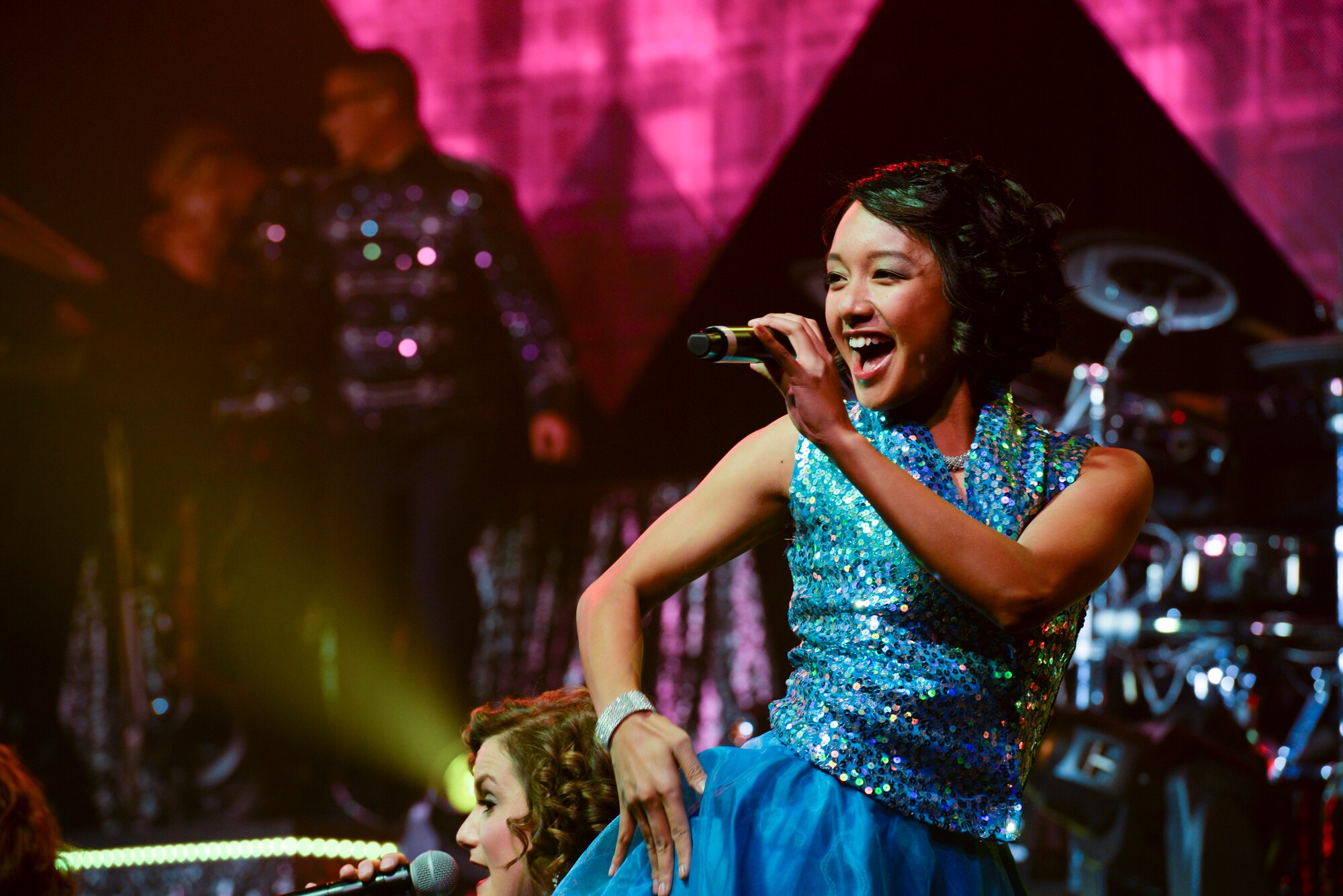 U.S. Air Force Airman 1st Class Christine David with the 96th Aircraft Maintenance Squadron, Eglin Air Force Base, Fla., sings during a show Nov. 6, 2015, in the Ernie Walker Theater at Eielson Air Force Base, Alaska. Tops in Blue’s primary purpose is to perform for military personnel and their families. (U.S. Air Force photo by Staff Sgt. Joshua Turner/Released)
