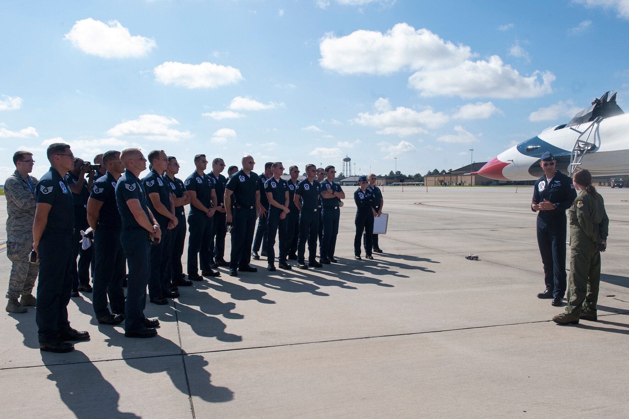Maj. Tyler Ellison, U.S. Air Force Thunderbirds operations officer, speaks with Caitlyn Chastain, a local news reporter, after their flight, Nov. 6, 2015, at Moody Air Force Base, Ga. He told her about the 120 enlisted personnel who make up 30 career fields that keep the Thunderbirds’ F-16 Fighting Falcons in the air. (U.S. Air Force Airman 1st Class Kathleen D. Bryant/Released)
